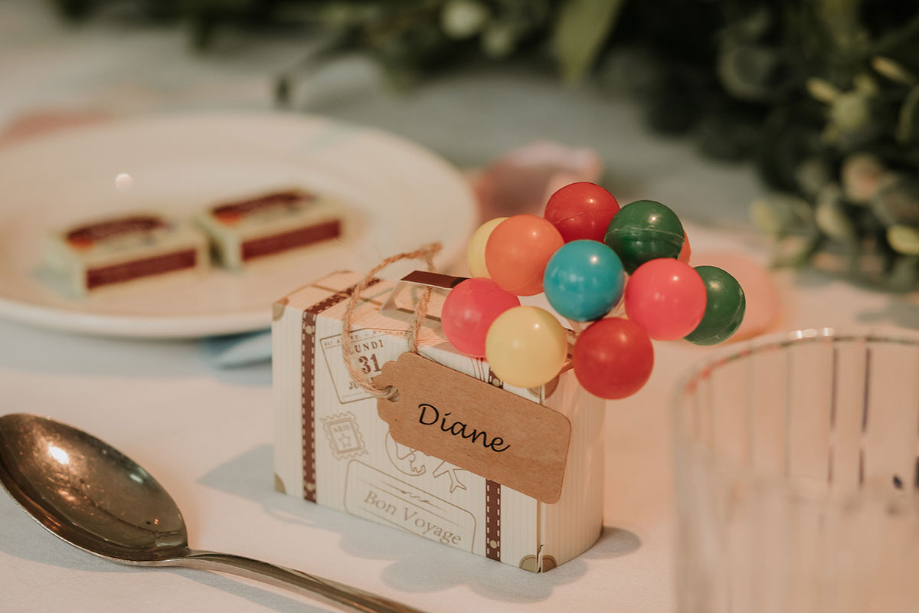 Wedding favour of mini suitcase and balloons inspired by Pixar's Up