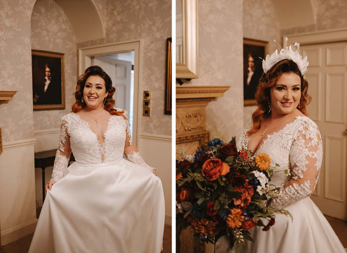 A bride poses in her lace-detailed wedding dress with a feather headband and large orange bouquet