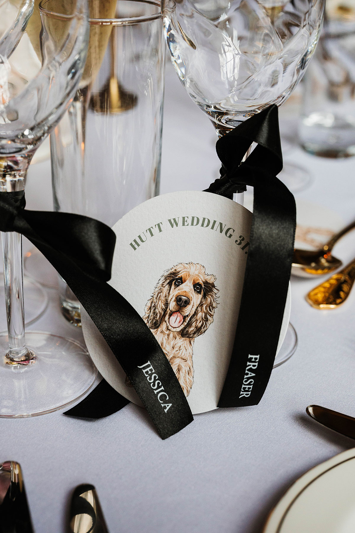Personalised wedding favour with illustrated dog coaster and ribbon place setting at Drumtochty Castle Aberdeenshire