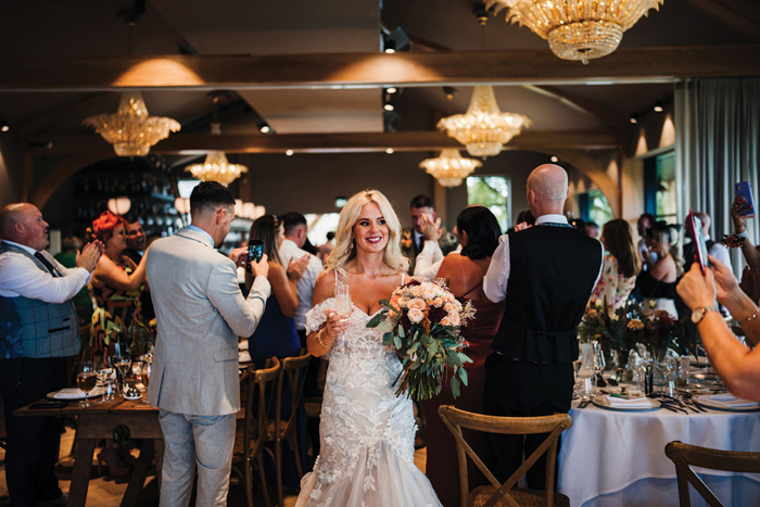 Bride walks into wedding reception