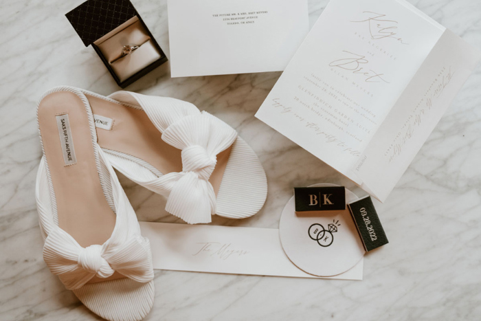 Wedding details with shoes ring and order of the day