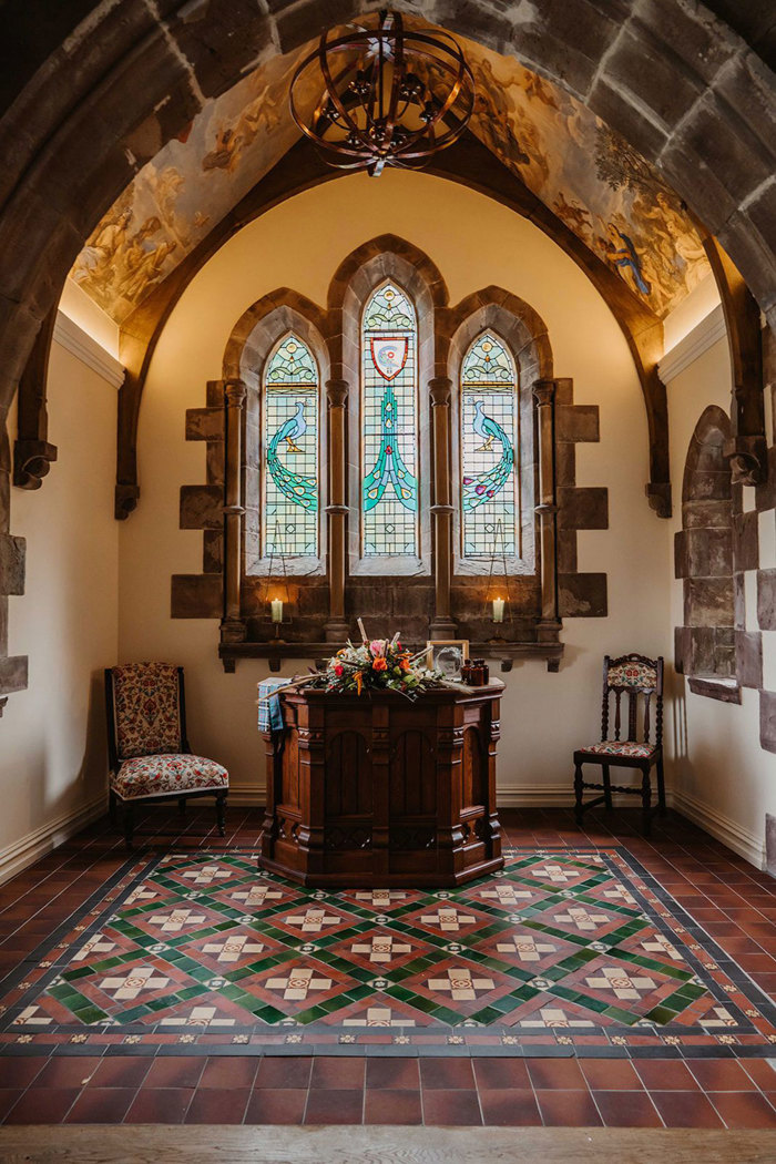 Culdees Castle Chapel with stained glass window and colourful ceramic tiles