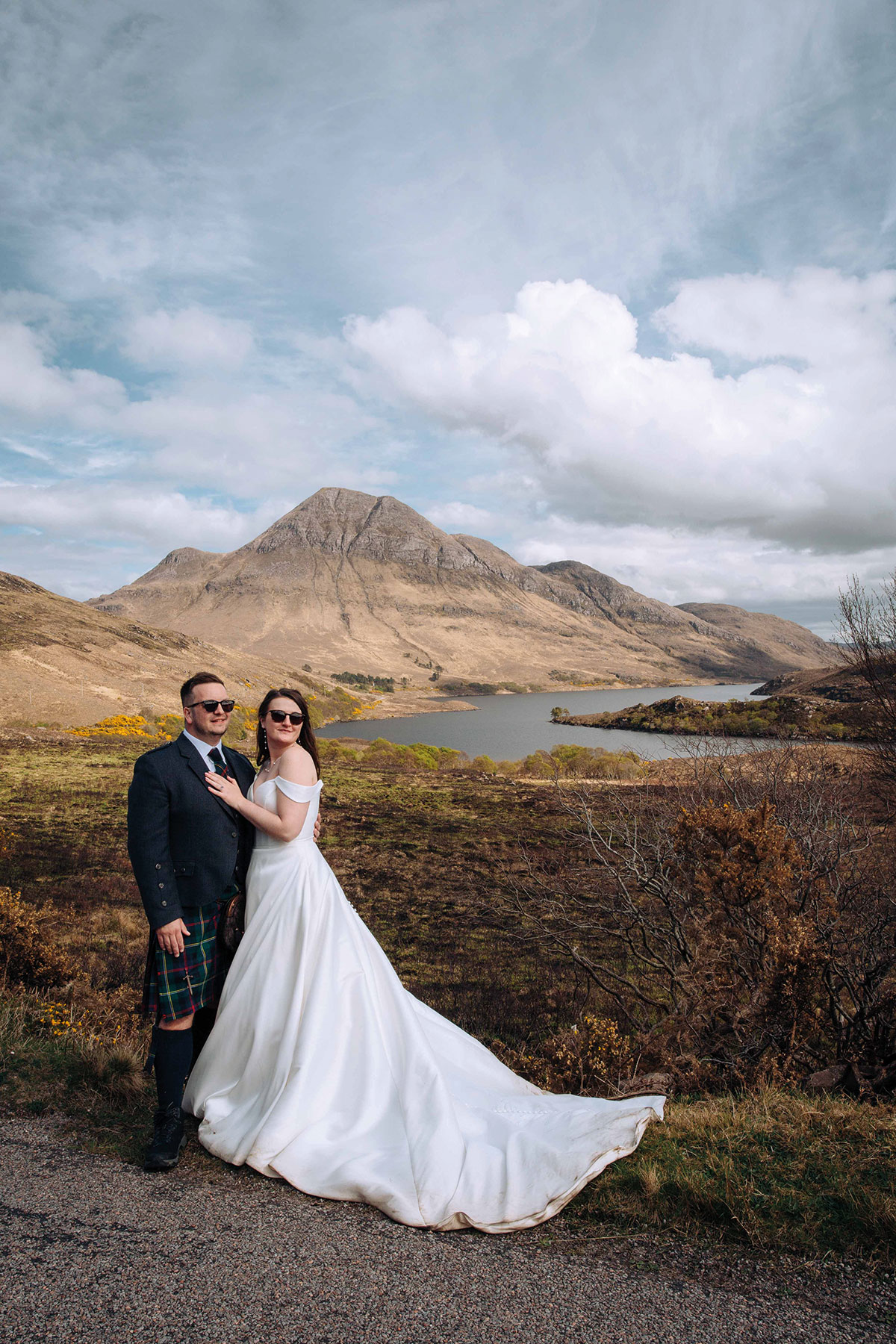 bride and groom hug while wearing sunglasses on wedding day in wester ross