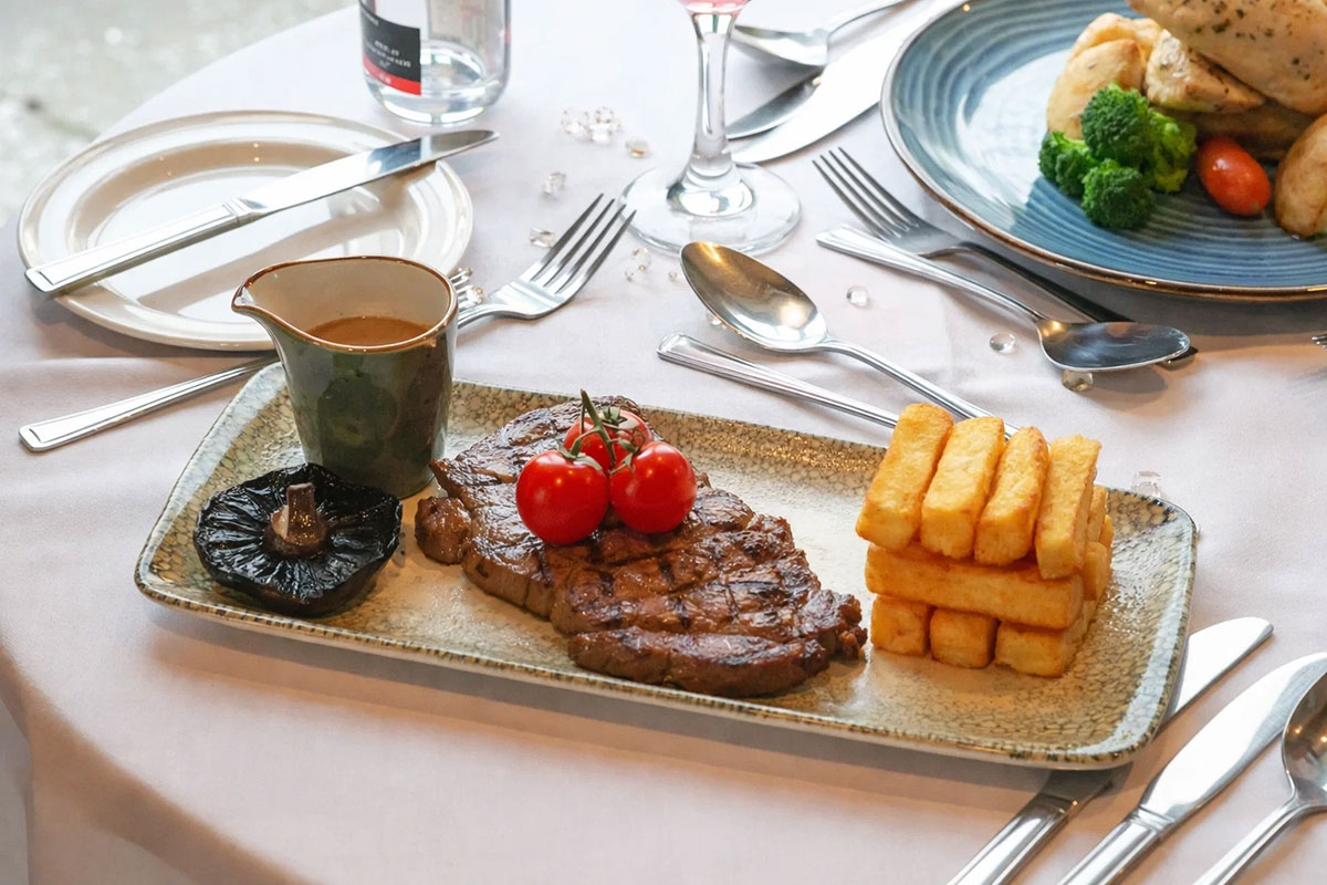 Wedding breakfast featuring sirloin steak served at Smiths at Gretna Green wedding venue in Scotland.