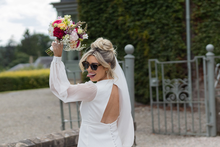 Bride Wearing Sunglasses Holding Bouquet