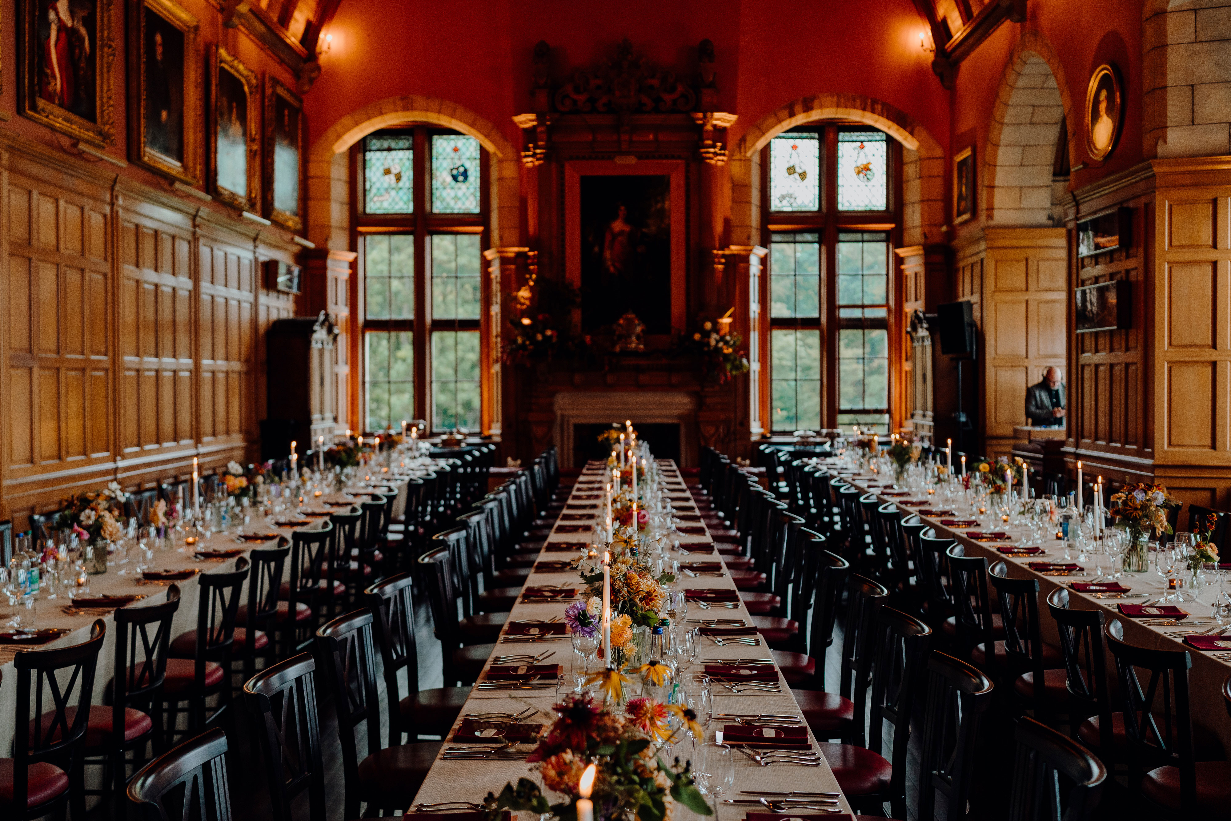 dinner set up with banquet style tables and black chairs at barnbougle castle
