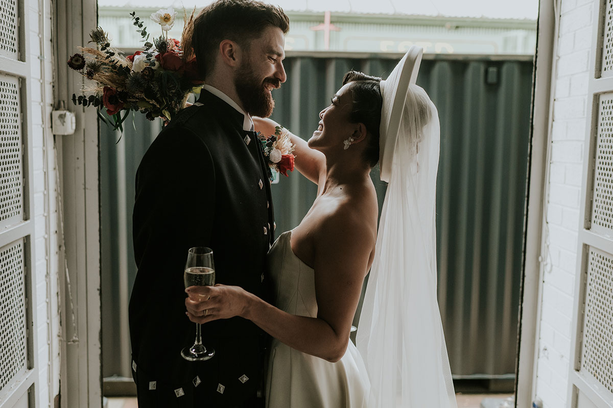 Bride and groom sharing a quiet moment with champagne at Barras Art and Design Glasgow wedding 