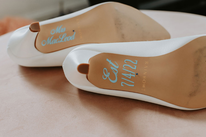 Bride's shoes with personalised details on the soles showing new moniker and date of wedding