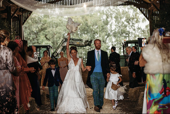 A Bride And Groom Cheering As They Walk Back Up The Aisle In A Shed On Boswells Estate