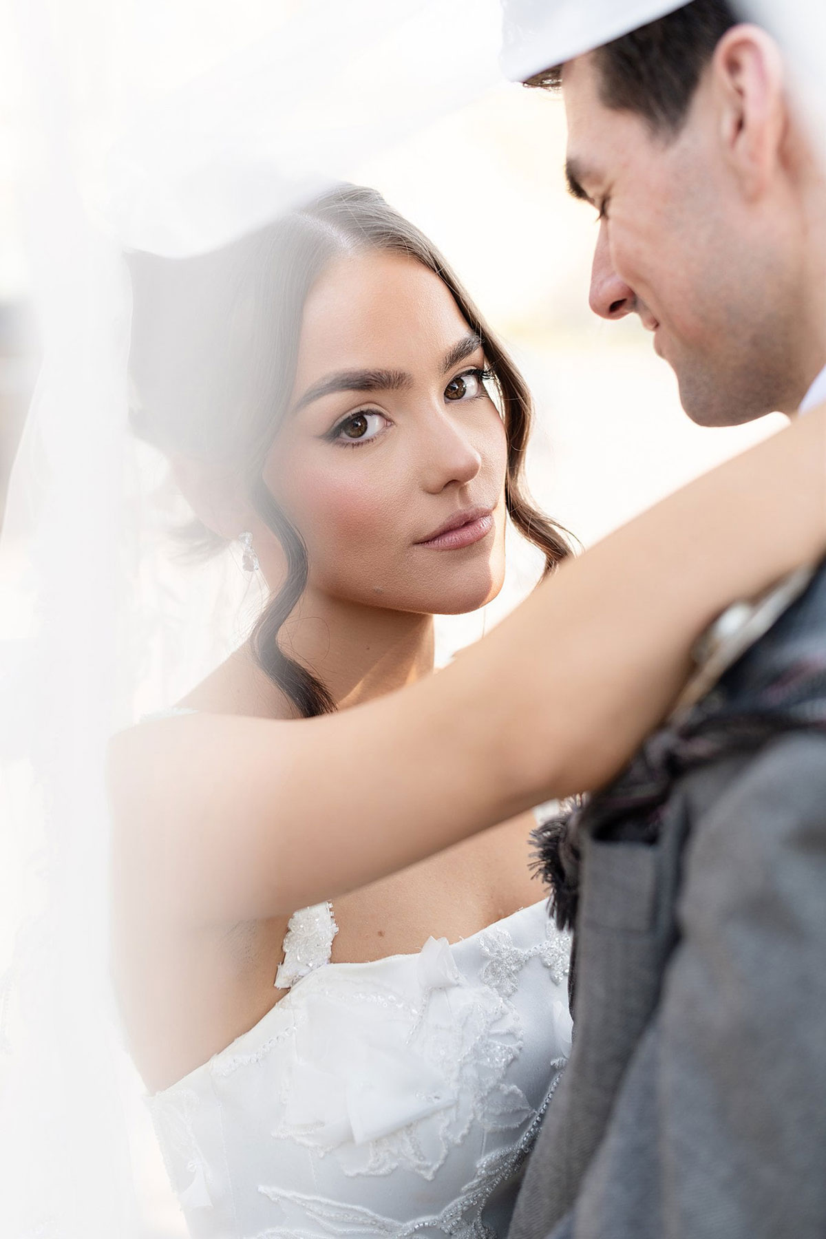 Soft bridal portrait through veil with groom during Old Course Hotel wedding photography in St Andrews.