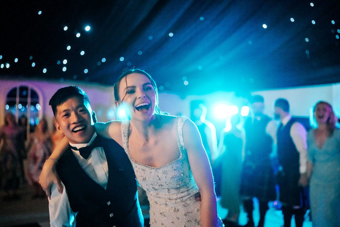 bride and groom hug on dancefloor during wedding reception at mar hall