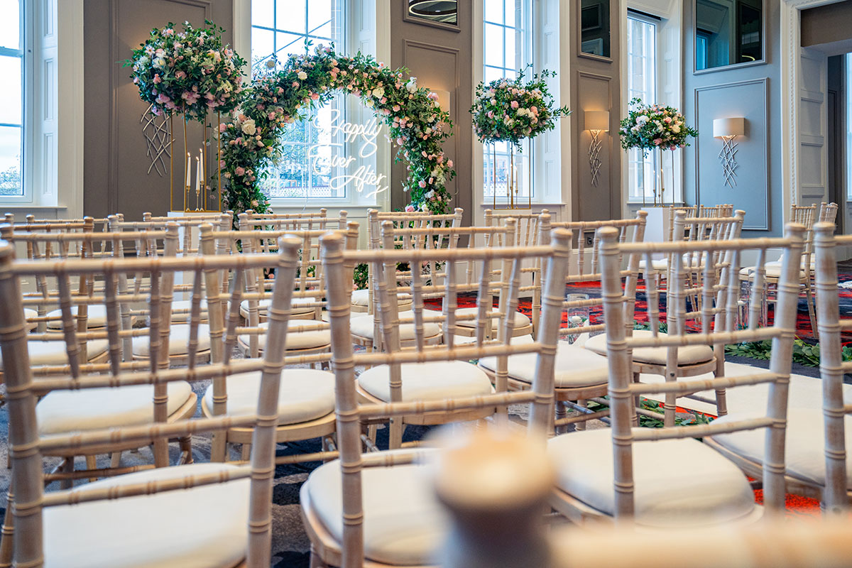 ceremony set up with Chivari Chairs and floral arch at clayton hotel glasgow