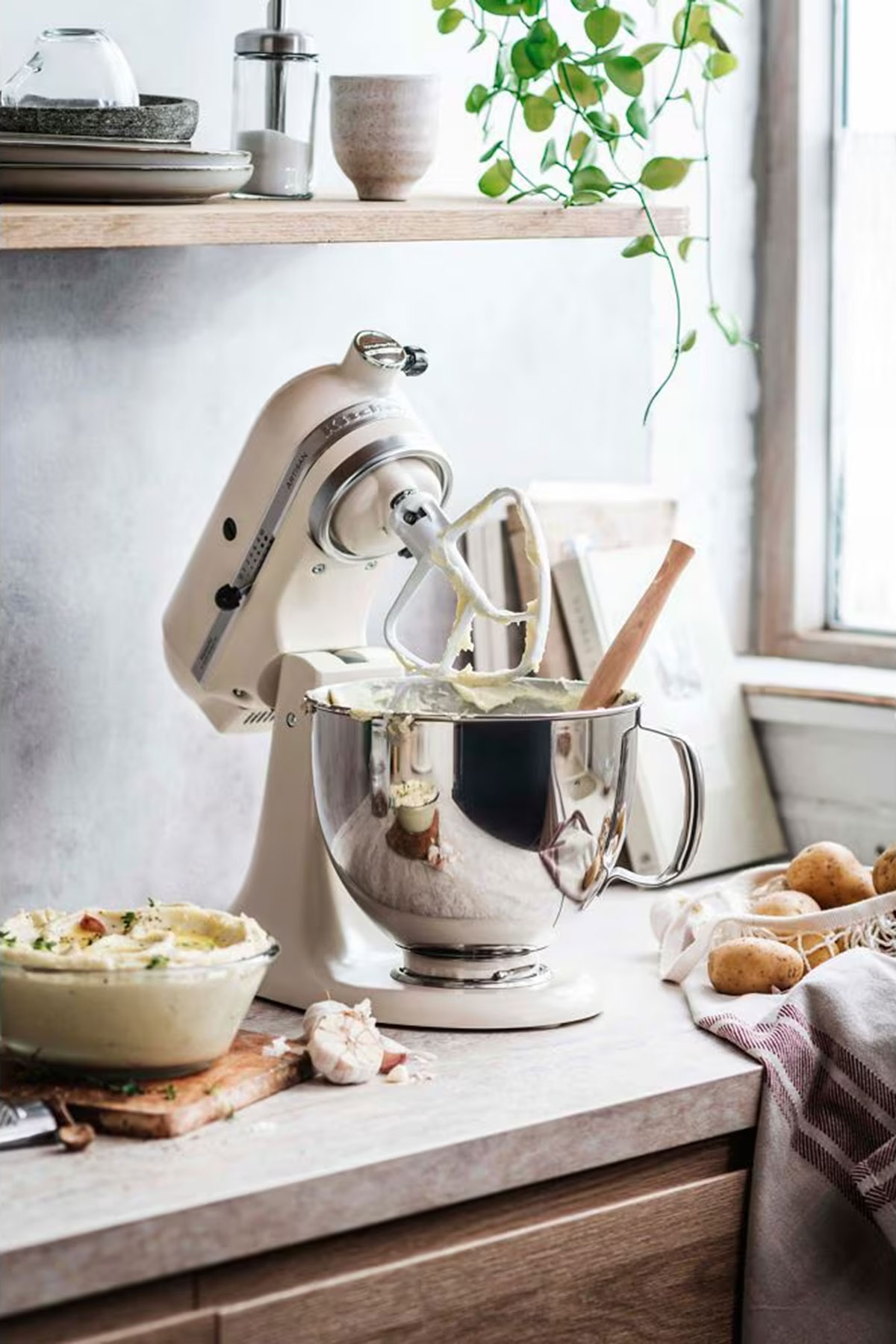 KitchenAid Artisan stand mixer in cream with mixing bowl and attachments, a classic wedding gift for couples who love baking