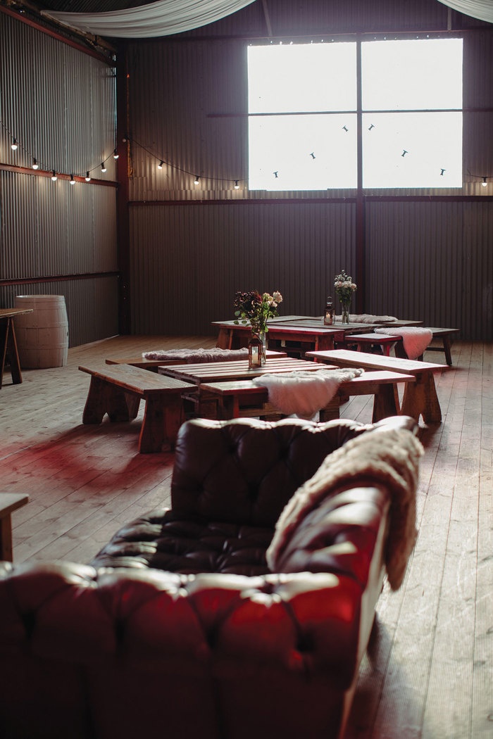 couch, flowers and benches for wedding at dalduff farm