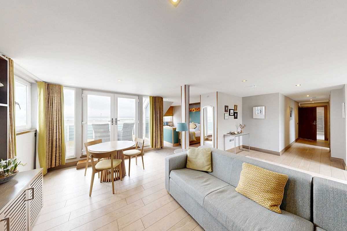 Sannox honeymoon suite at The Waterside Hotel with lounge space, balcony access and coastal views