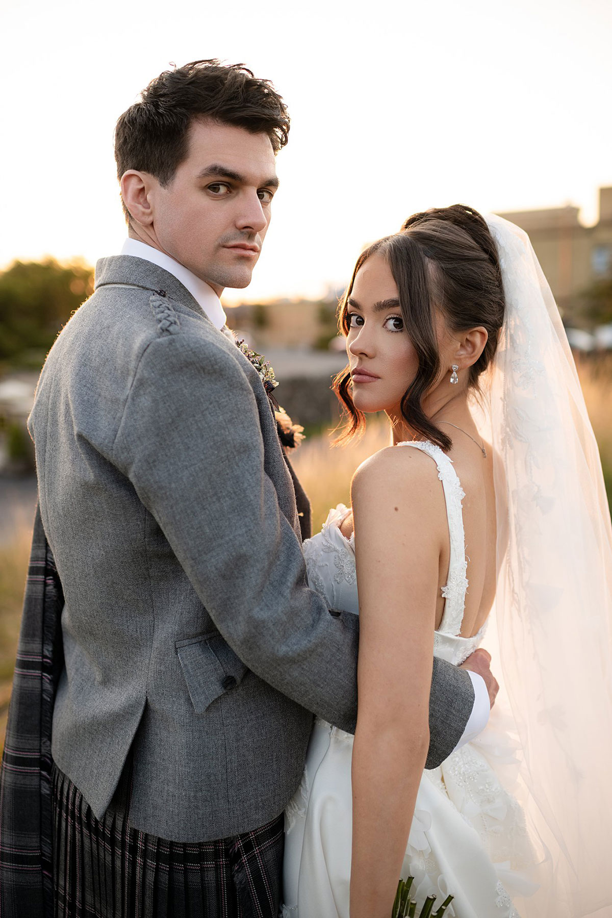 Bride and groom posing together during sunset portraits at Old Course Hotel wedding in St Andrews.