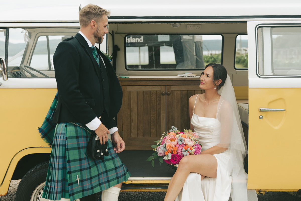bride and groom at Dougarie Boathouse with yellow VW campervan
