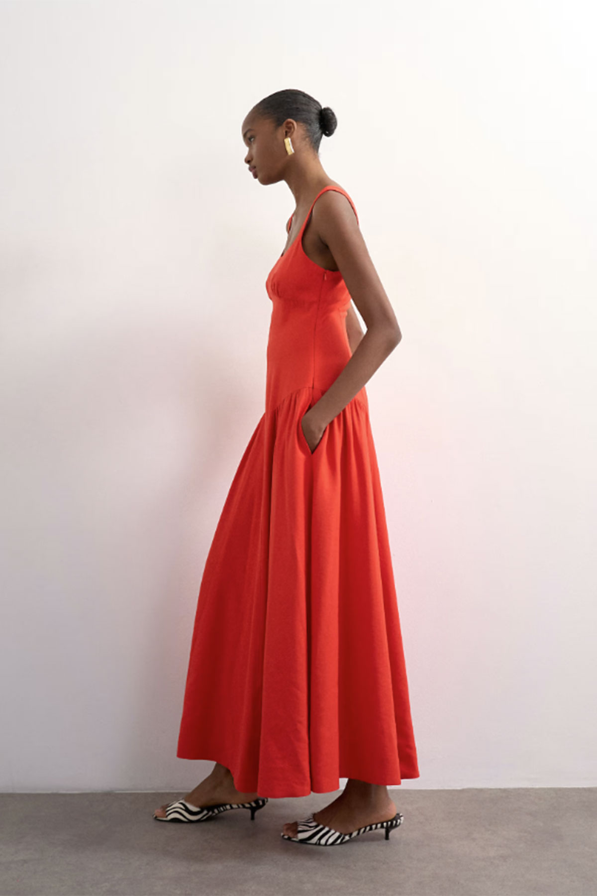 Red dropped-waist maxi dress with fitted bodice and full flowing skirt
