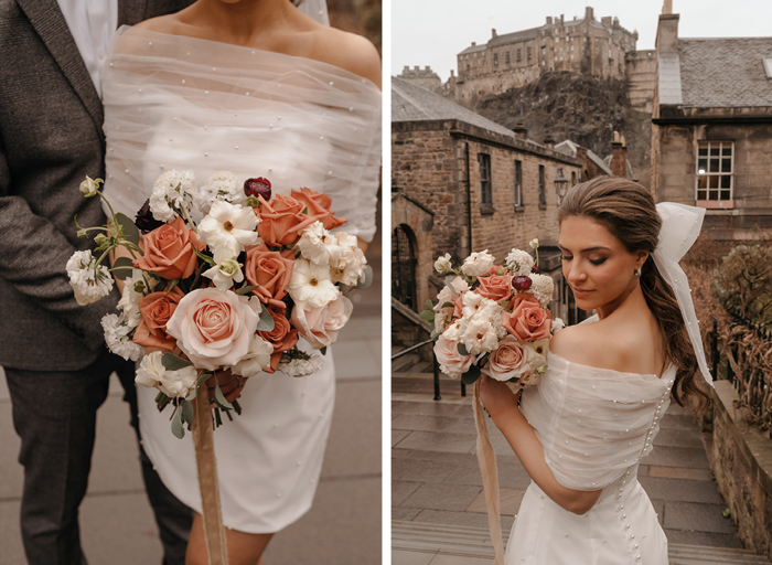 A bride holds an orange and white bouquet from The Petal Studio in front of Edinburgh Castle