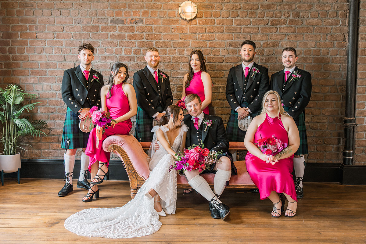 Bride and groom posing with their bridesmaids and groomsmen for a wedding party portrait