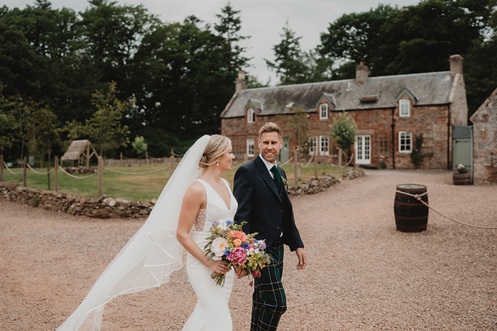 A bride And Groom Walking In The Grounds Of Wedderlie House