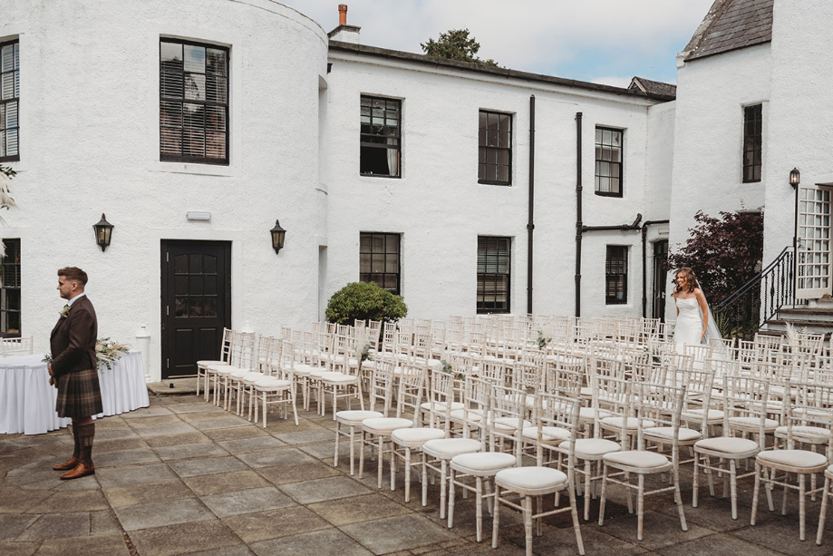 Bride walks towards groom for sweet first look