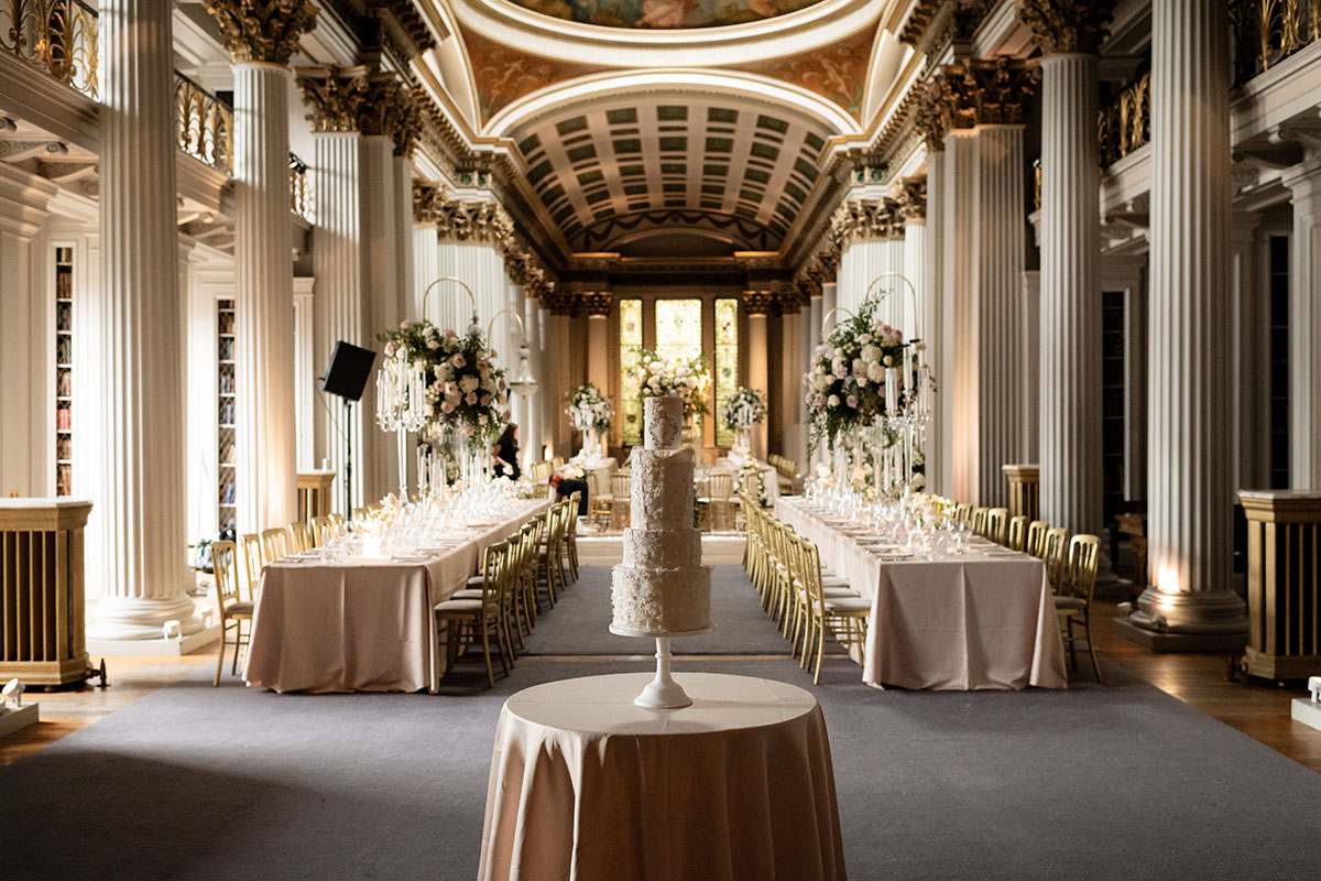 Signet Library wedding reception setup with long tables and wedding cake