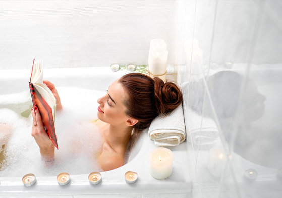 Woman soaks in bubble bath