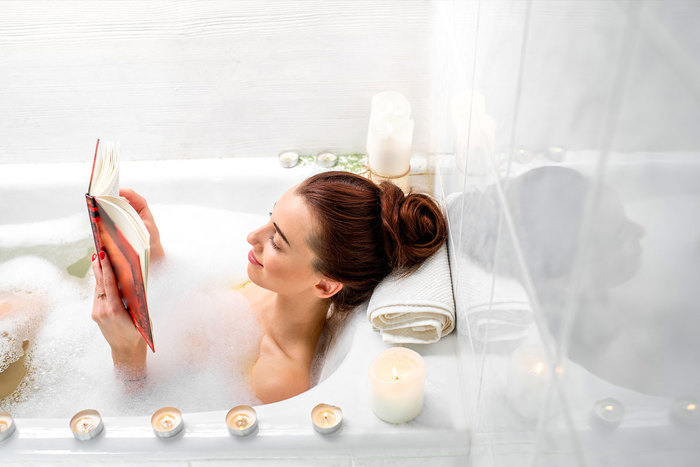 Woman soaks in bubble bath