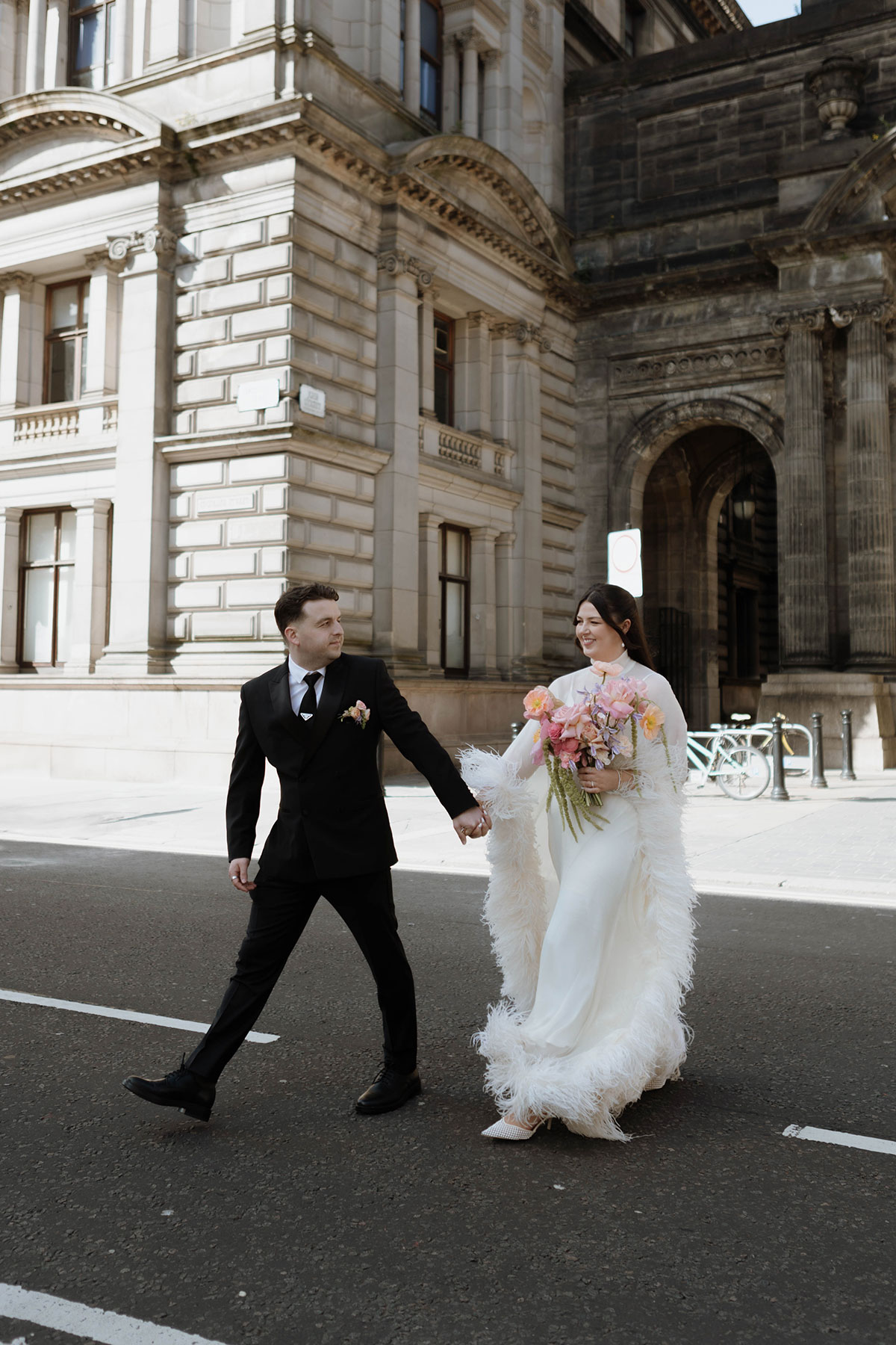 Stylish bride and groom portrait on a sunny Glasgow city street