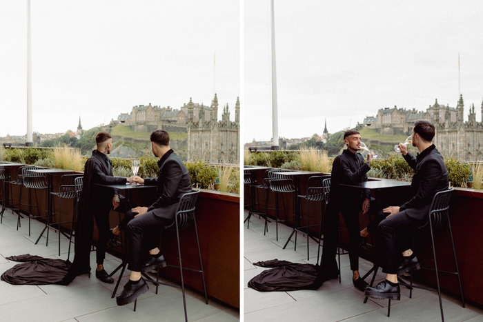 Two People Drinking Champagne On A Rooftop With Edinburgh Castle In Background