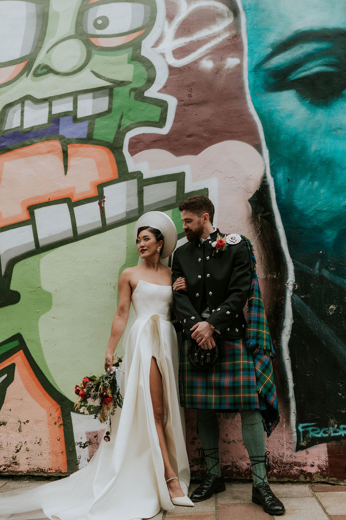 Bride and groom portrait against colourful graffiti wall in Glasgow near BAaD wedding venue