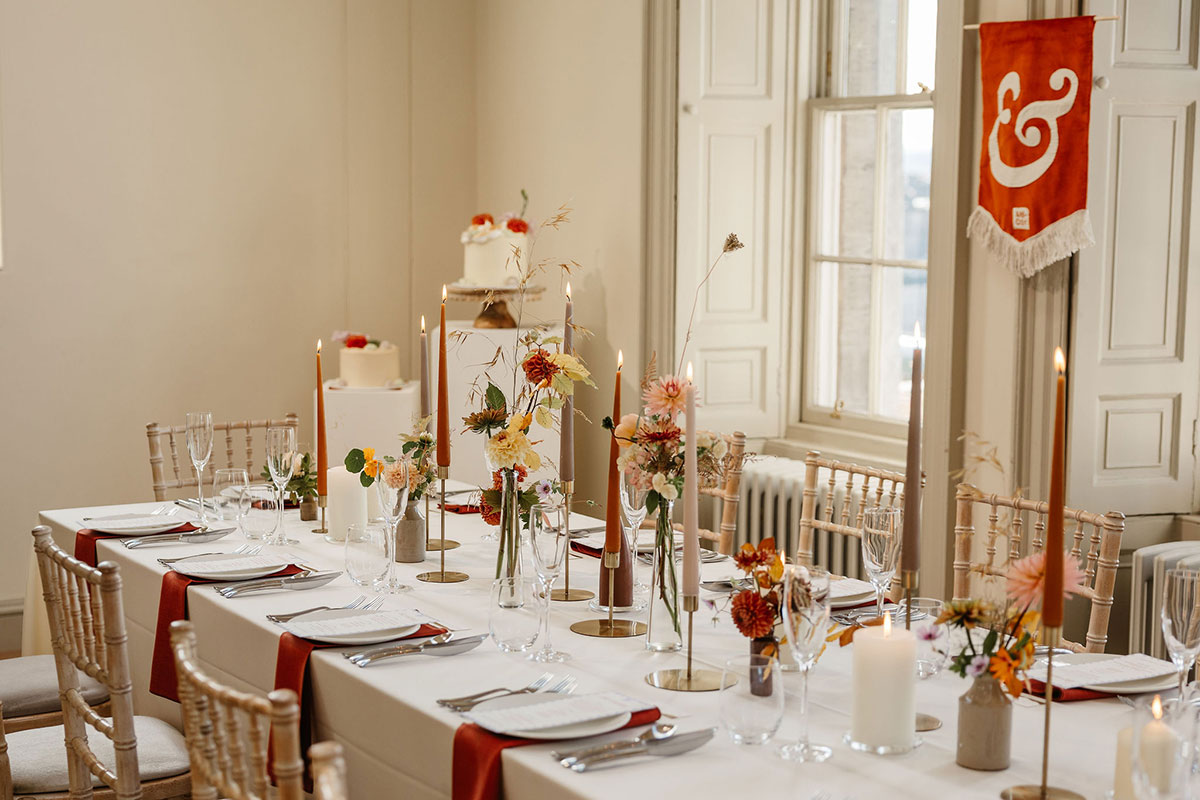 Wedding table styling inside The Collective Edinburgh with candles, florals and long dining table