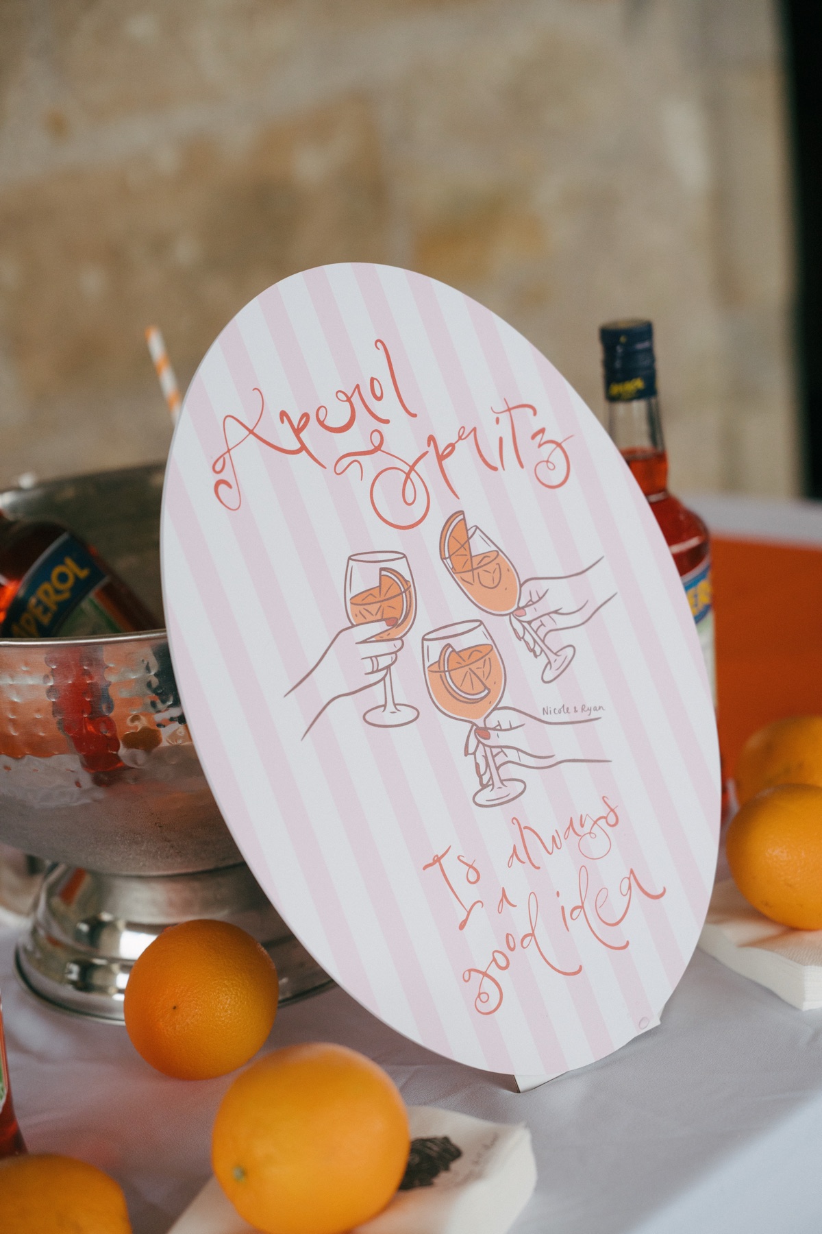Personalised Aperol Spritz bar sign featuring illustrations of cocktails and Nicole and Ryan’s names at their Barnbougle Castle wedding.
