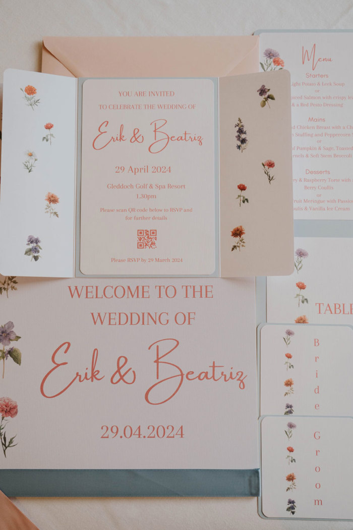 wedding signage and invitations for the wedding of Erik & Beatriz in pale pink and orange with lots of flowers on the design