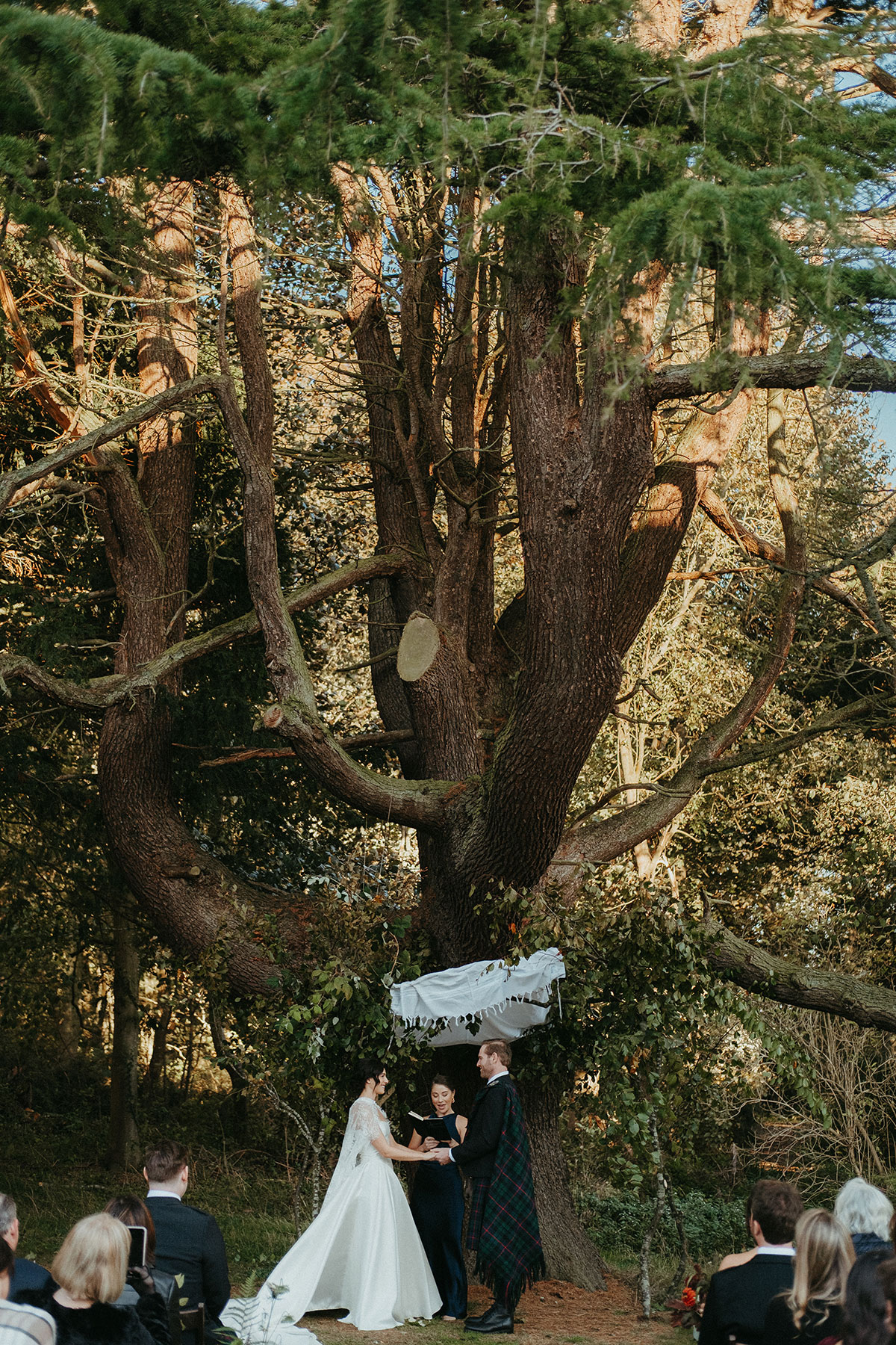 Bride and groom exchange vows beneath a chuppah during an intimate outdoor ceremony at Cambo Country House in Fife.