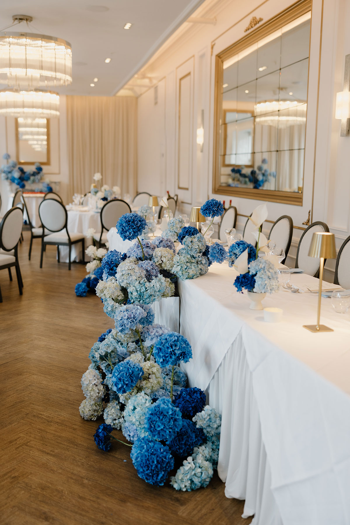 Wedding reception table at The Exchange Glasgow styled with cascading blue hydrangeas and white linens