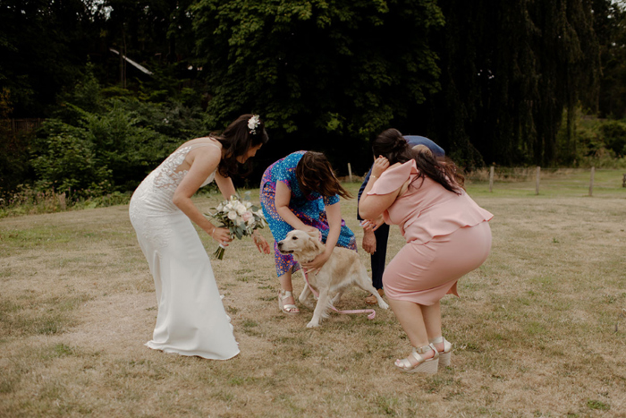 Family portrait of bride and groom, the bride's two daughters and golden retriever 