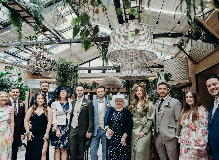 a group of people posing for a wedding photo at Kimpton Charlotte Square Hotel in Edinburgh