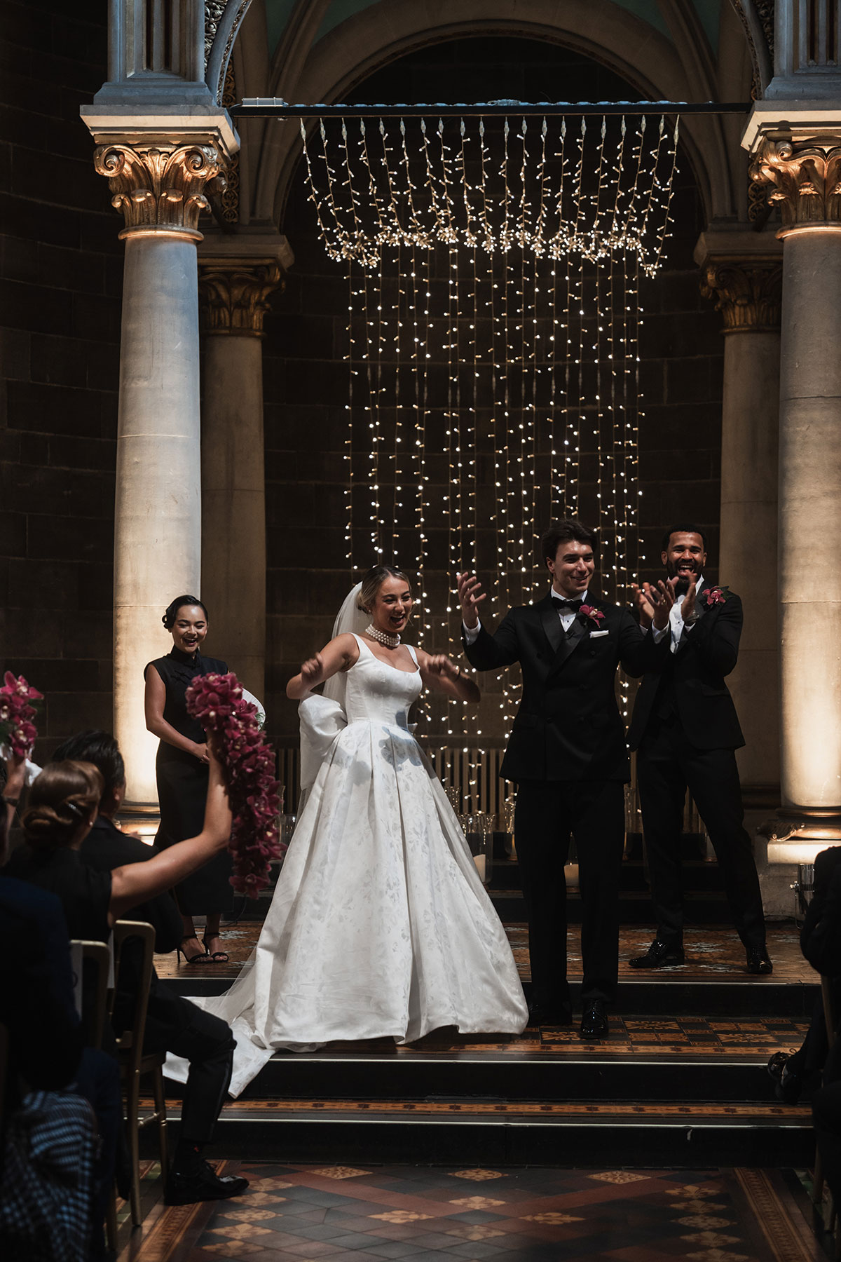 Newlyweds celebrating and cheering during their wedding ceremony at Mansfield Traquair