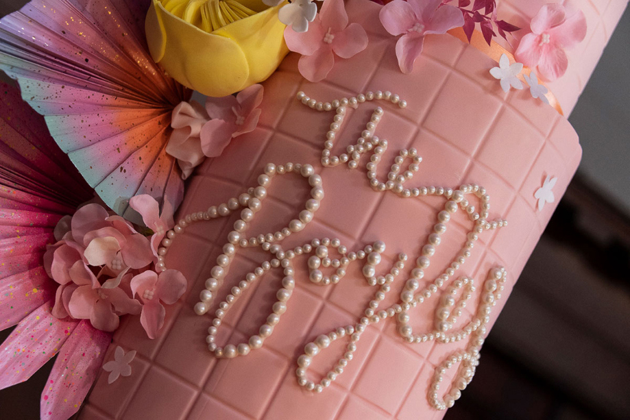 Colourful pink flower wedding cake with 'The Boyles' written in edible pearls made by Cake Days A Week