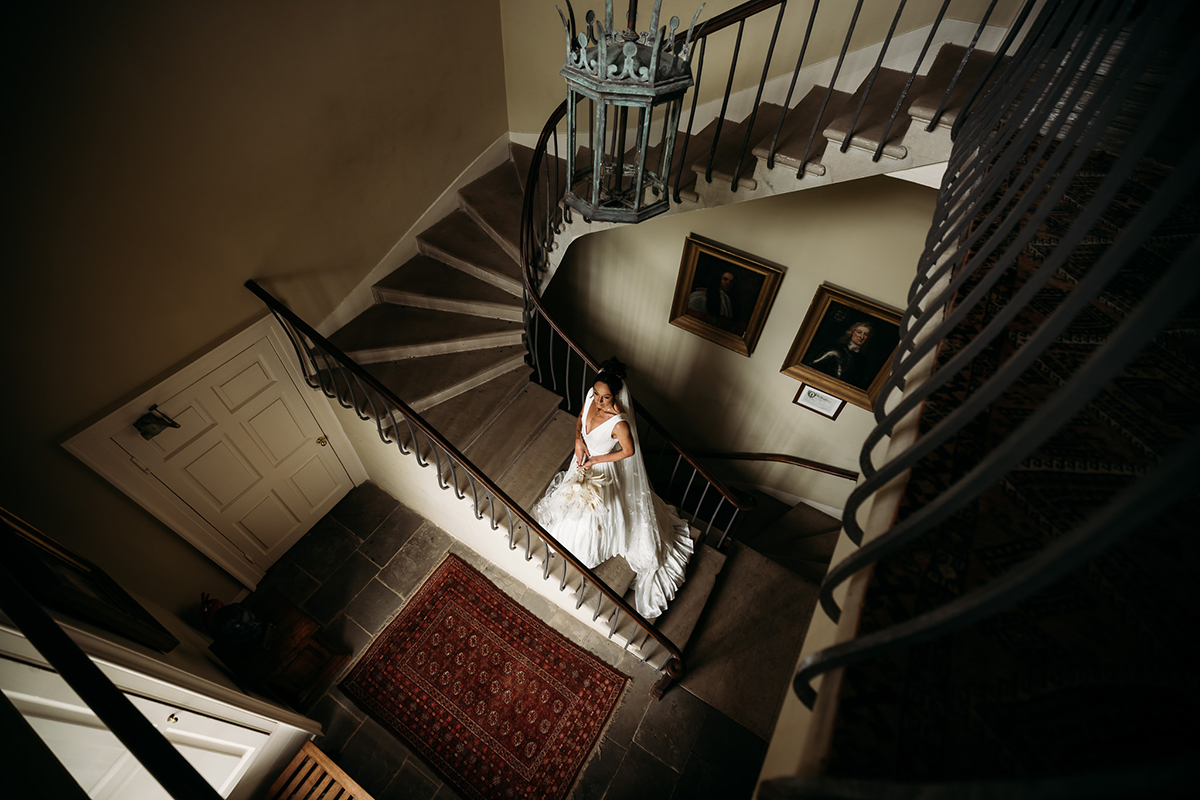 A Person Wearing A White Dress On A Staircase
