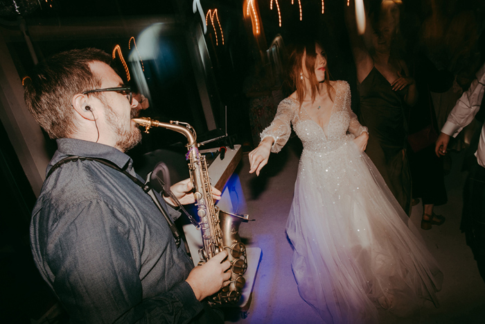 Bride dances to saxophonist at Boreland Loch Tay Wedding