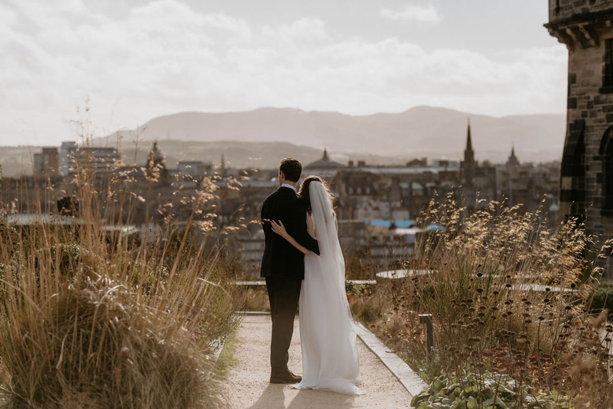 Couple embracing outdoors at The Collective Edinburgh overlooking the city skyline