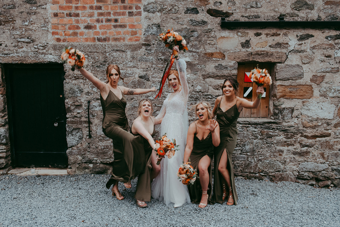 Bride and bridesmaids pose for pictures