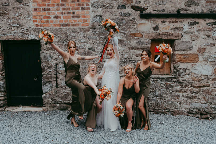 Bride and bridesmaids pose for pictures