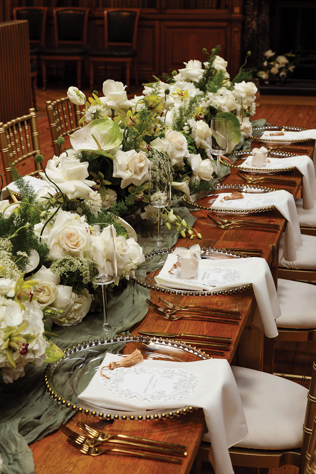 Close-up of wedding table styling with white flowers, gold cutlery and stationery at Edinburgh wedding venue RCPE