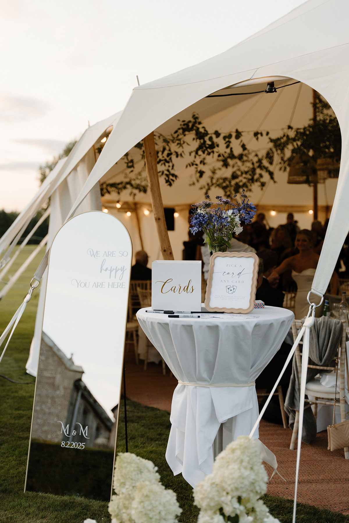 Wedding reception entrance styling with mirrored welcome sign, card table and sailcloth marquee at an outdoor Scottish wedding
