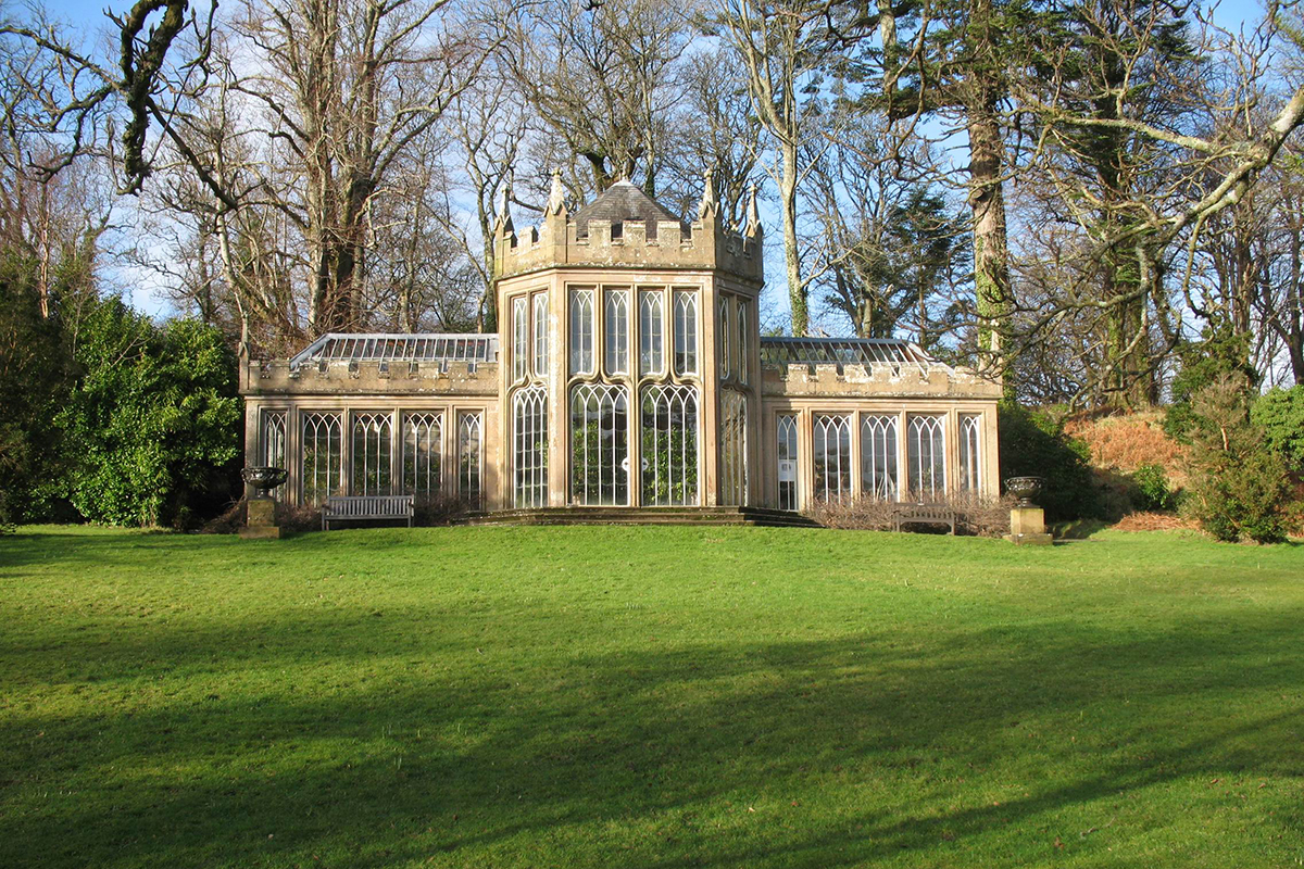 The Camellia House at Culzean Castle, a glass-fronted Gothic-style orangery surrounded by lawns and woodland.