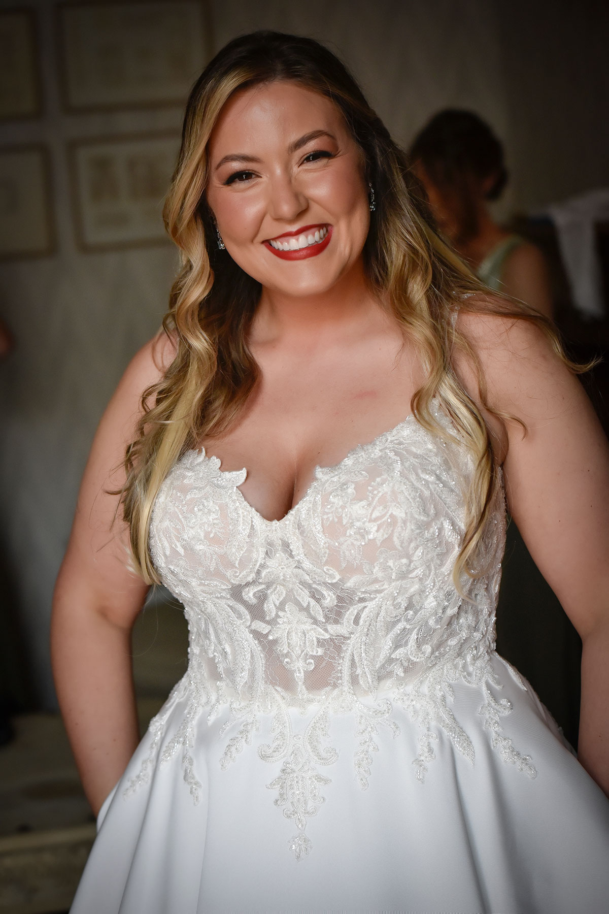 portrait photo of a bride in ballgown wedding dress with v-neckline smiling directly at camera